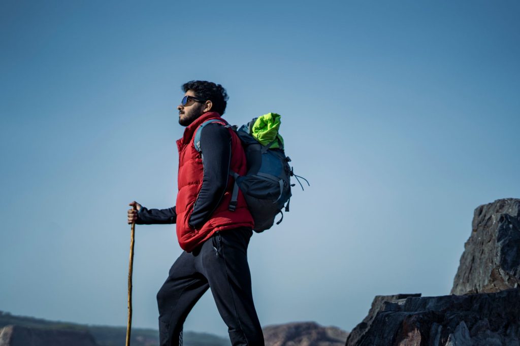 Turysta z plecakiem i kijkiem trekkingowym na szlaku w Indiach
